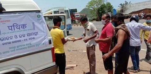 印度樂施會同事和夥伴團體在奧里薩邦（Odisha）一個交通交匯處向農民工派發飯盒。不少排隊的人已經兩天沒有進食，但仍要步行多數百公里才回到家中。